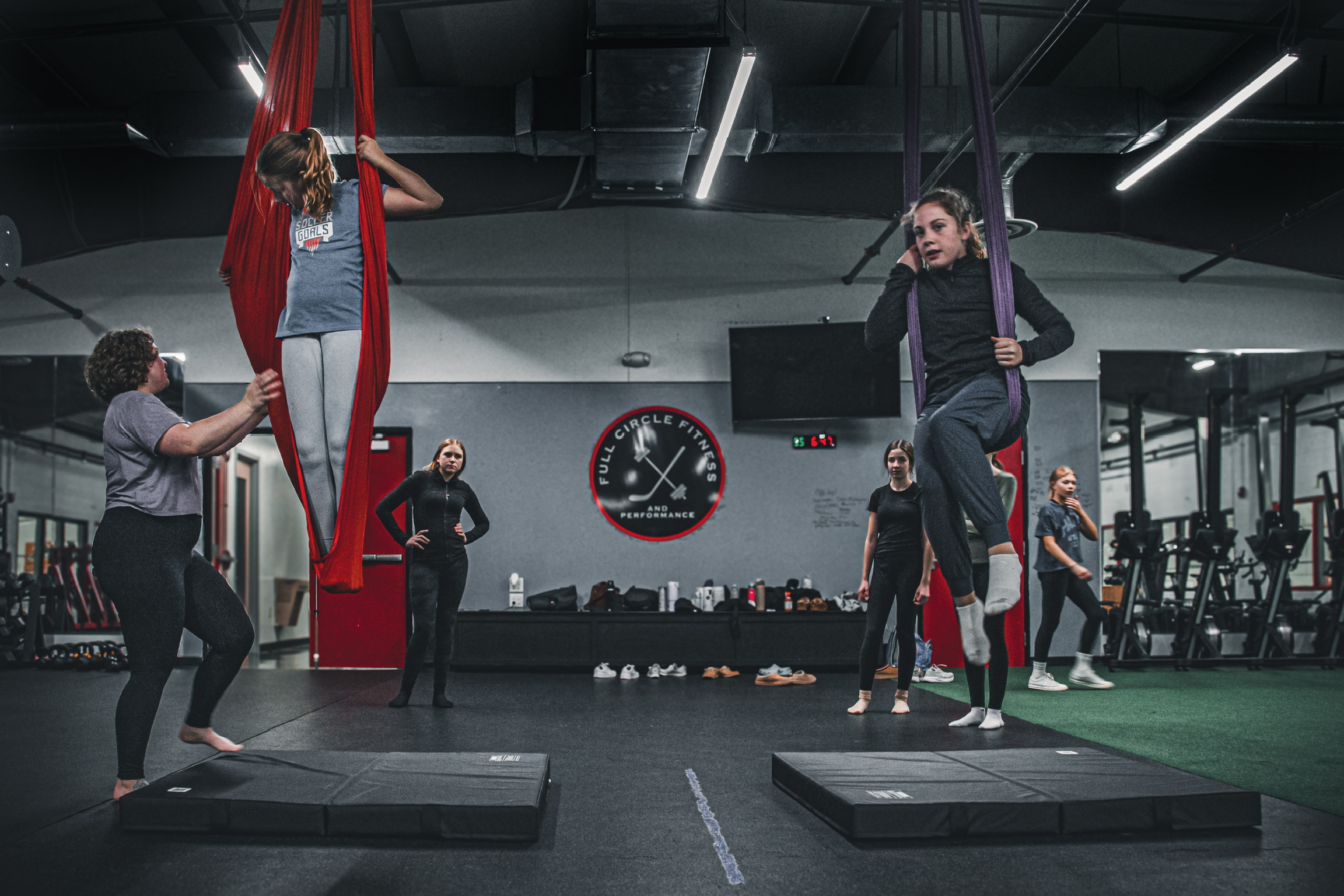 Aerial class at Full Circle Fitness with coach spotting